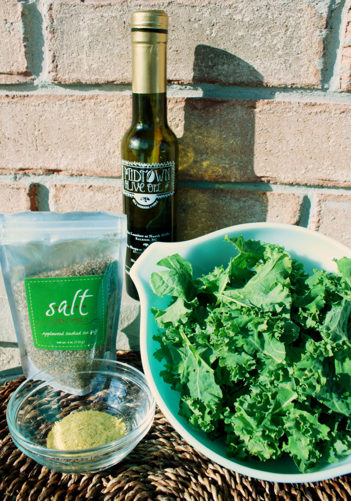 All the ingredients I used for these kale chips: basil-infused olive oil, applewood smoked sea salt, nutritional yeast, and a head of kale torn into bite-sized pieces