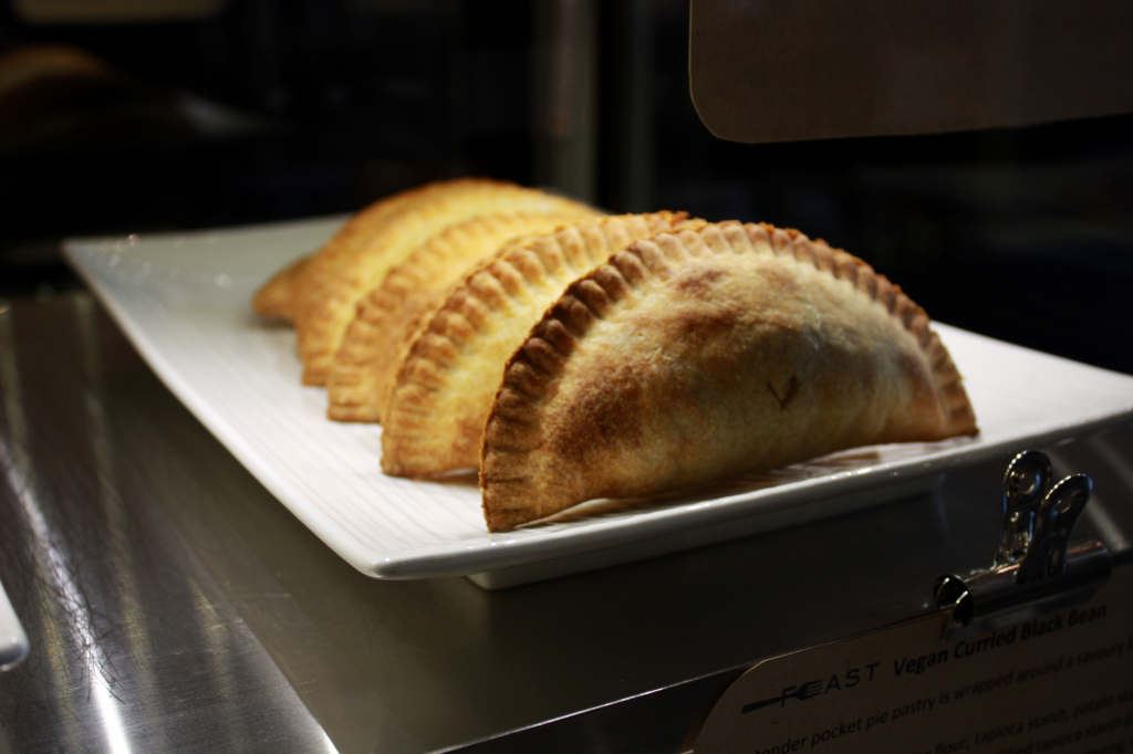 Vegan Curried Black Bean pocket pies in display case